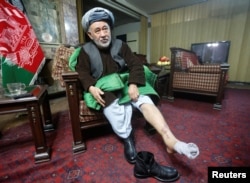 Ahmad Ishchi, who said he was beaten and detained by Afghan Vice President Abdul Rashid Dostum, displays an injury on his leg during an interview at his home in Kabul on December 13.