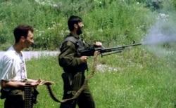 Serbs advancing on positions near Srebrenica in July 1995.