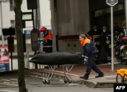 A medical worker removes a victim of the attacks outside the Maalbeek subway station on March 23.