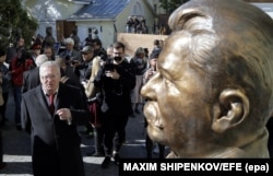 Vladimir Zhirinovsky speaks in front of a Josef Stalin bust as he attends a ceremony unveiling a series of new busts at the Alley of Rulers in Moscow in September 2017.