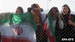 Female fans watch from a distance as the Iranian national soccer team trains in Tehran.