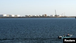 A speed boat passes by oil docks at the Iranian port of Kalantari in the city of Chabahar, east of the Strait of Hormuz, on January 17.