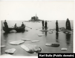 Monks from the Konevsky Monastery pose on the stones of Lake Ladoga, just north of St. Petersburg, around 1900.