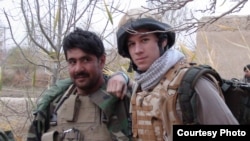 Patrick Hennessey (right) poses with Qiam, an Afghan National Army officer, in Helmand in 2009.