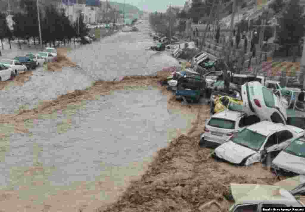 Vehicles are piled up after being swept away by flash floods in Shiraz.