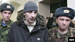 Vasily Aleksanian (center) arrives at a Moscow court in February.