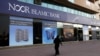 A woman walks past a branch of the Noor Islamic Bank in Dubai. Although there have long been many Islamic banks in the Middle East and Southeast Asia, they are now also spreading rapidly in the West. (file photo)