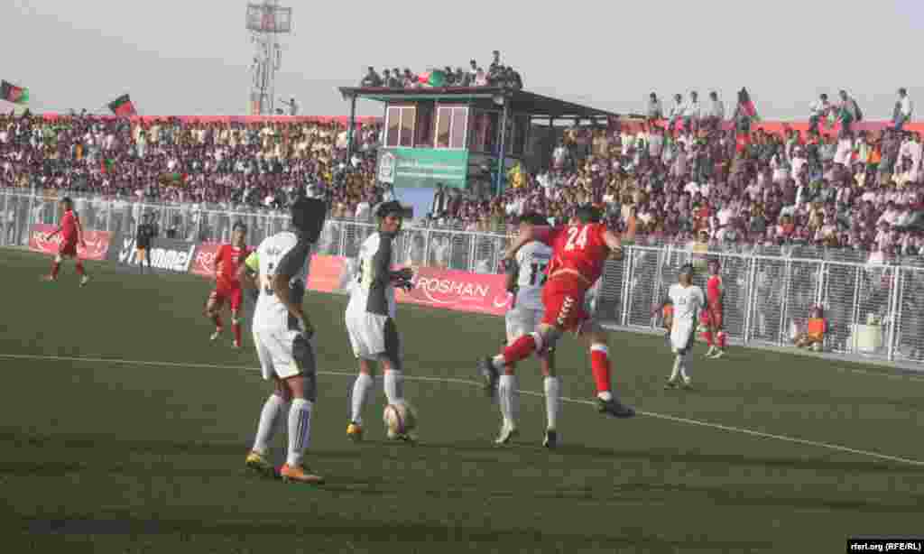 Afghan national players (in red) compete with Pakistani players during the match in Kabul.