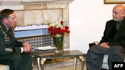 Afghan President Hamid Karzai (right) talks with U.S. General David Petraeus in Kabul.