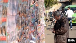 An Iranian man looks at election posters during a week of campaigning ahead of a parliamentary poll on March 2