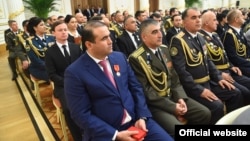 The president's son-in-law, Shamsullo Sohibov, pictured in the blue suit, controls a vast amount of wealth in Tajikistan. 