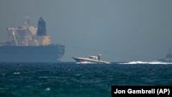 A U.A.E. coast-guard vessel passes an oil tanker off the coast of Fujairah.