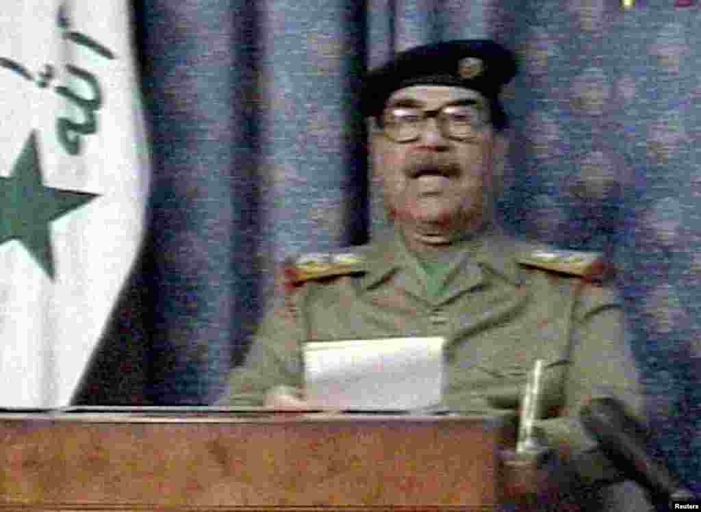 Iraqi President Saddam Hussein appears on state television just hours after the United States launched its invasion to overthrow him. In his speech, Saddam said, &quot;The criminal little Bush has committed a crime against humanity.&quot;