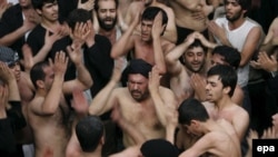 Iranians mourn during the Ashura ceremonies at the Karbala Mosque in Tehran in 2007.