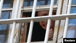 Yulia Tymoshenko is seen through a prison window in Kyiv in November.