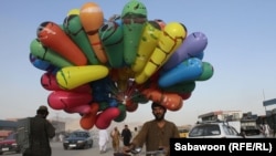 A man sells balloons on the streets of Kabul