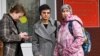 Feminist activist and artist Yulia Tsvetkova (center) stands with her mother, Anna Khodyreva (right), and lawyer Irina Ruchko following a court session in Komsomolsk-on-Amur in April 2021.