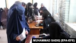 Women cast their votes in Kandahar during the flawed parliamentary elections in Afghanistan in October 2018. A lack of credible information about the biometric system could hamper their participation in the upcoming presidential election.