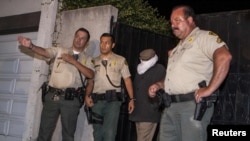 Mark Basseley Youssef (second from right), the man thought to be behind the controversial smear video "Innocence Of Muslims," is led from his southern California home by sheriffs in September.