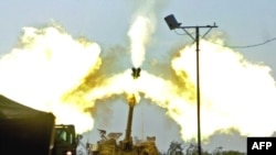 Israeli artillery fires toward the Gaza Strip from the Israeli side of the Israel-Gaza border on January 4.