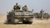 Turkish military armored personnel carriers take positions on the Turkish-Syrian border near the Akcakale border crossing on October 4.