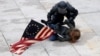 A riot police officer detains a pro-Trump protester as mobs stormed the U.S. Capitol on January 6.