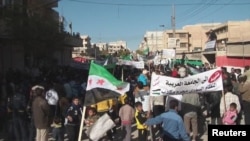 Syrian demonstrators protest against the regime in Al-Baidah, near Homs, last month.