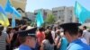 Crimean Tatars picket the building of the Consulate General of Russia in Simferopol, demanding the resignation of Russian Consul General Vladimir Andreyev on May 23. 