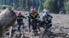 Rescue workers carry the body of a victim of a landslide, near Shovi, about 140 kilometers northwest of Georgia's capital, Tbilisi, on August 4.