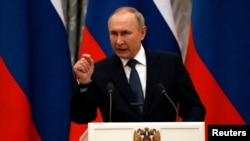 Russian President Vladimir Putin gestures during a press conference with French President Emmanuel Macron in Moscow on February 7.