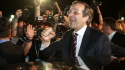 The leader of the conservative New Democracy party, Antonis Samaras, is cheered by supporters in Athens on June 17.