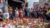 People taking part in a spontaneous Pride Parade arrive at the London Pub, a popular gay bar in Oslo, to pay tribute to victims of the shooting after the official event was canceled following the attack on June 25, 2022.