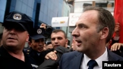 Fatmir Limaj greets supporters in Pristina after he was acquitted on September 17.