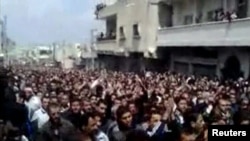 Thousands of people attend a mass funeral for pro-democracy protesters in the city of Daraa earlier this month. (file photo)