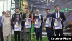 Supporters hold posters of Afghan parliamentary candidate Zuhra Nawrozi in Kabul.