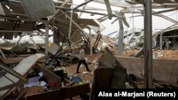 A worker checks damages at a civilian airport under construction which, according to Iraqi religious authorities, was hit by a U.S. air strike in Kerbala on March 13.