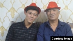 A family photograph of Uzbek opposition activist Khurram Berdiev (right) with his son. 