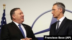 U.S. Secretary of State Mike Pompeo (left) and NATO Secretary-General Jens Stoltenberg prior to a meeting of the alliance's foreign ministers in Brussels on December 4.