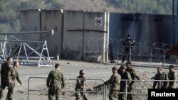 Kosovo Force (KFOR) soldiers from Armenia and Germany put up barricades at the closed Serbia-Kosovo border crossing of Jarinje on September 28.