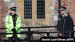 British Prime Minister Theresa May talks with local police officials in Salisbury.