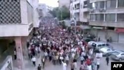 A video grab shows antigovernment protesters marching in Hama on April 29.