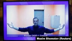 Russian opposition leader Aleksei Navalny is seen on a screen during a video court hearing on January 28 to consider an appeal on his arrest. 