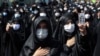 Mourning women wear protective face masks to help prevent the spread of the coronavirus during the annual ceremony commemorating Ashura at the Saleh shrine in northern Tehran on August 30.