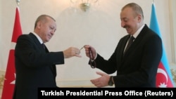 Azerbaijani President Ilham Aliyev (right) receives prayer beads from Turkish counterpart Recep Tayyip Erdogan in Baku during a visit in February.