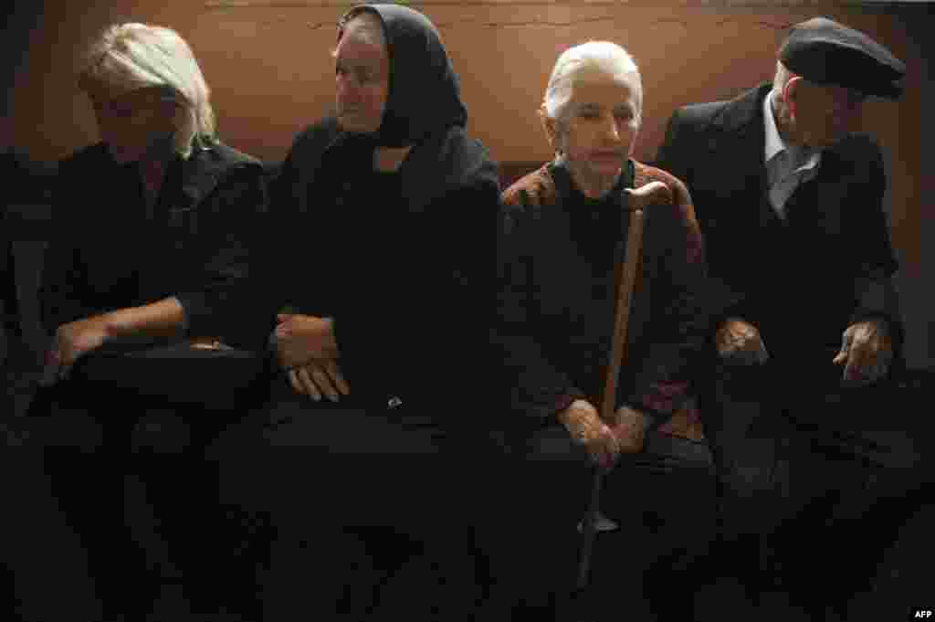 Kosovar Serbs wait to cast ballots at a polling station in the town of Gracanica.