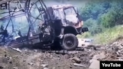 A video grab appearing to show the charred remains of the vehicle. 