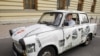 An East German Trabant decorated with reproductions of newspaper stories of the 1989 Pan-European Picnic arrives for the 20th anniversary of the gathering in Sopron.