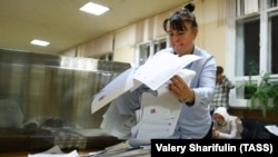 A Russian official in Moscow takes part in vote counting following parliamentary elections at the weekend. 