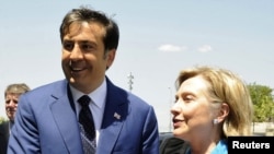 While staunch ally Georgia and its President Mikheil Saakashvili (left) can boast the most aid in the region, U.S. Secretary of State Hillary Clinton will struggle to maintian aid levels for other countries.