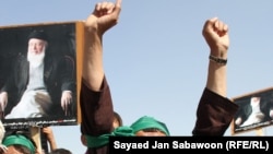 Supporters of slain former Afghan President Burhanuddin Rabbani shout slogans and hold up his portrait during a protest against the Taliban and Pakistan in Kabul on September 27.